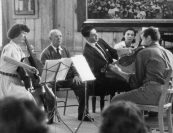 "Every time you play it, it’s different. The way you find variety time after time after time," Madeline marvels to Pablo Casals in their 1955 NBC documentary. "It must be different - how can it be otherwise?" replies Casals. "Nature’s so, and we are nature… Everything changes. You see one thing in a way, and some minutes after, you are different. So art is nature. Art is movement is color. Our impressions of Bach or any music changes continually, continually. We find the beauty in a certain place that we didn’t get before, and this is why everything is new. Everything is new. There are always new intersections and new joys because it is new, and it must be new.” Later, this perspective greatly informs Madeline's work with young musicians at Marlboro. Arnold Steinhardt recalls how she "urged them away from rote playing, encouraging a sense of improvisation and that a work played today should sound different tomorrow.” This, he says, was a fundamental "lesson on how music should and shouldn’t be played.” 
<br>
<i>Madeline Foley, Pablo Casals, Claude Frank, Lilian Kallir, and Michael Tree, 1962.</i> 